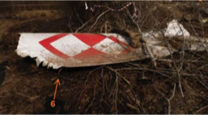 Fig. 25 (Left). The terminal part of the left wing (bottom shell) with the flap track fairings (6). In the background the right -hand- side horizontal stabilizer (3) [17]. The upper shell has been crushed and its pieces are in remote locations.